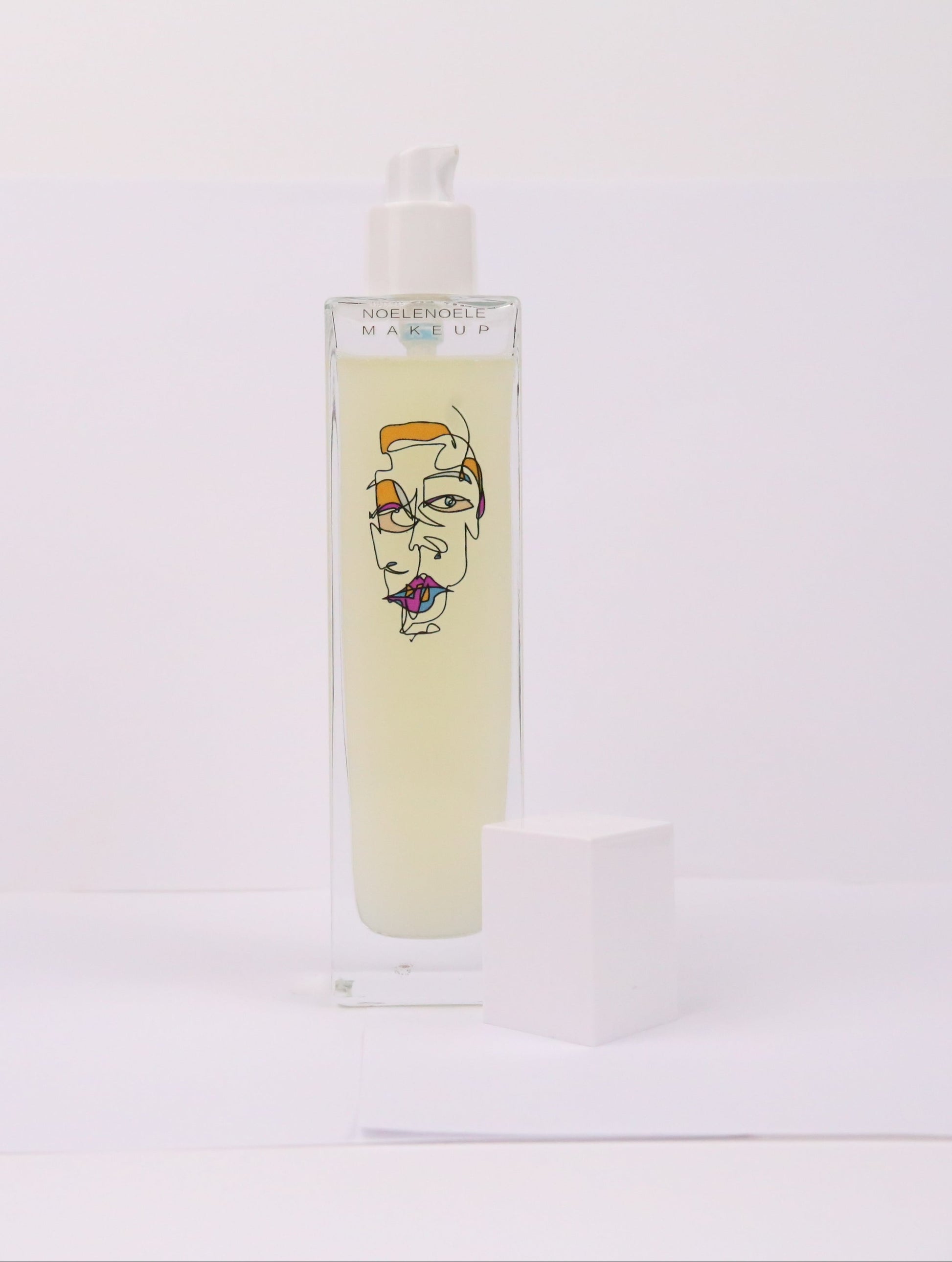 Skincare bottle with artistic design on a white background